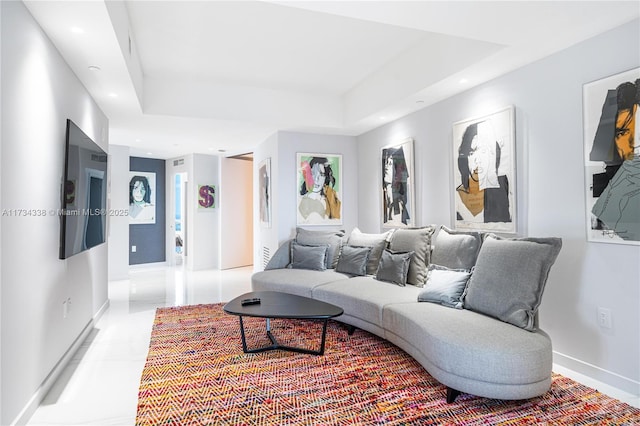 living room featuring a tray ceiling