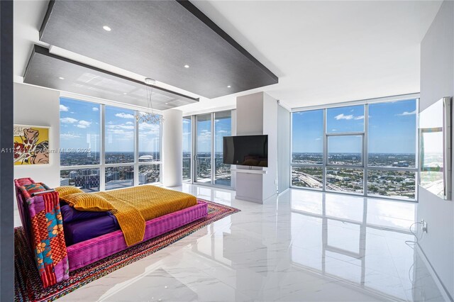 bedroom featuring a wall of windows and access to exterior