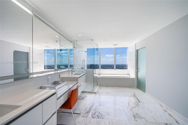 bathroom with vanity and independent shower and bath