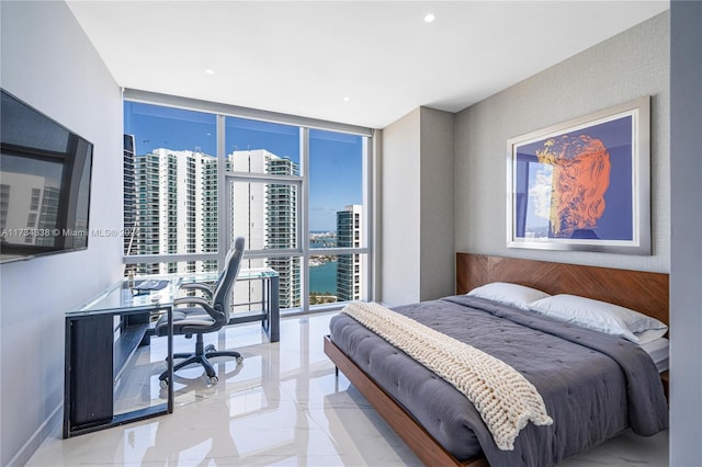 bedroom featuring expansive windows and a water view