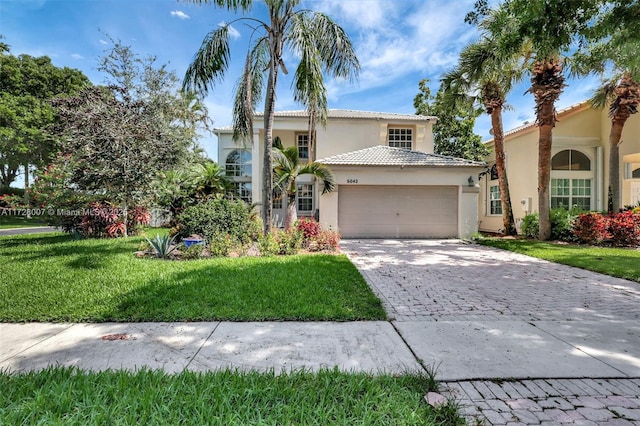 mediterranean / spanish-style home with a garage and a front yard