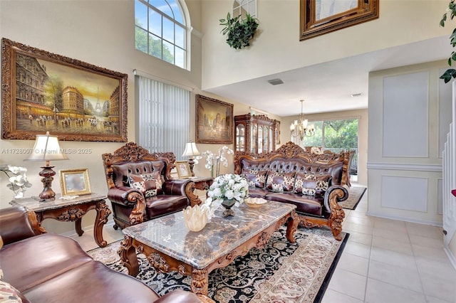 tiled living room with an inviting chandelier and a high ceiling