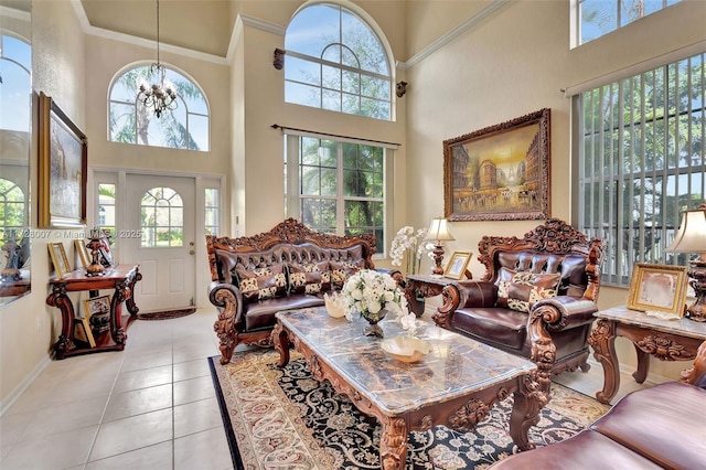 tiled living room with a towering ceiling, a wealth of natural light, and a chandelier