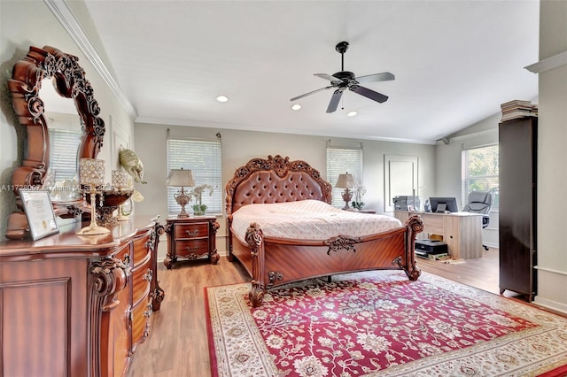 bedroom featuring lofted ceiling, light hardwood / wood-style flooring, ornamental molding, and ceiling fan