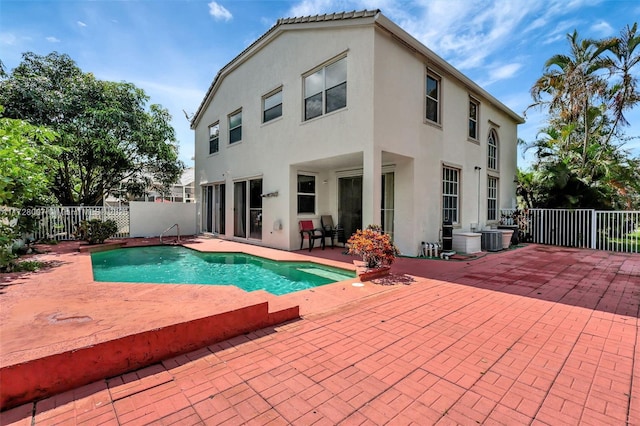 view of swimming pool with central AC unit and a patio