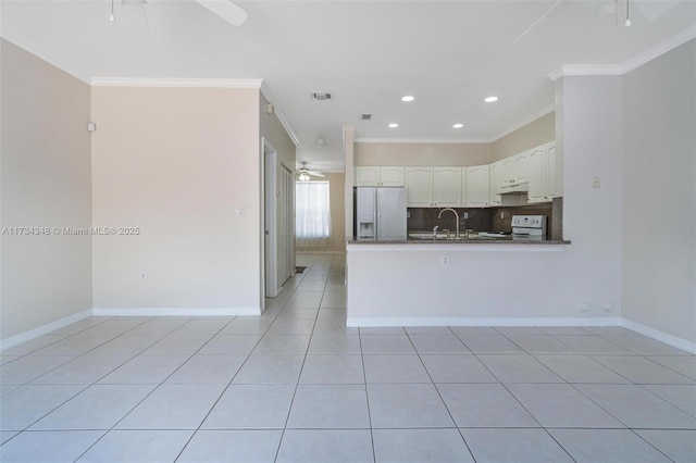 kitchen featuring light tile patterned flooring, stainless steel fridge with ice dispenser, white cabinets, kitchen peninsula, and electric stove