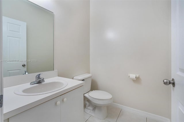 bathroom featuring vanity, tile patterned floors, and toilet