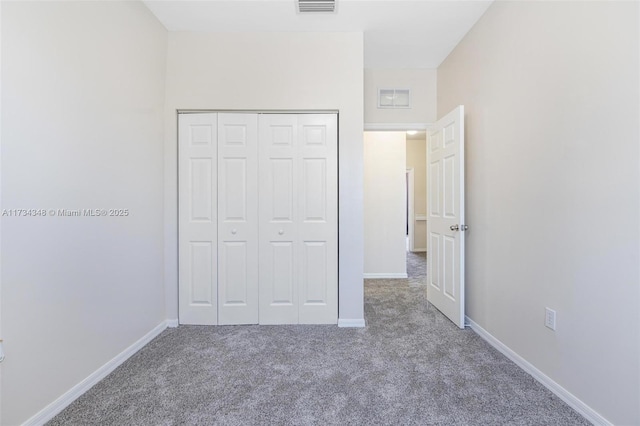 unfurnished bedroom with carpet floors and a closet