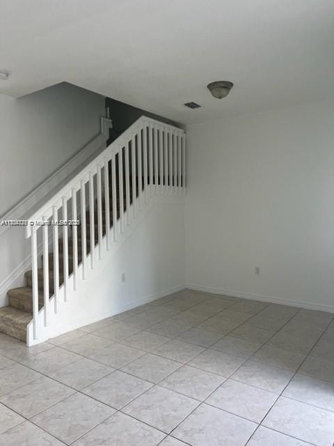 stairs with tile patterned flooring