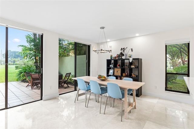 dining space featuring expansive windows and a notable chandelier