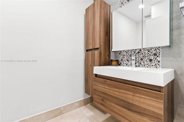 bathroom featuring tasteful backsplash, vanity, and tile patterned floors