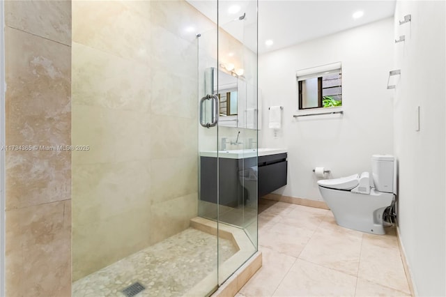 bathroom featuring vanity, a shower with shower door, and toilet