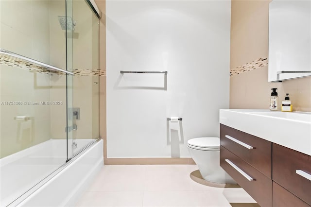 full bathroom featuring enclosed tub / shower combo, vanity, toilet, and tile patterned floors