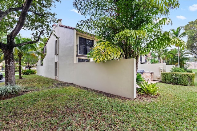 view of side of home with a lawn