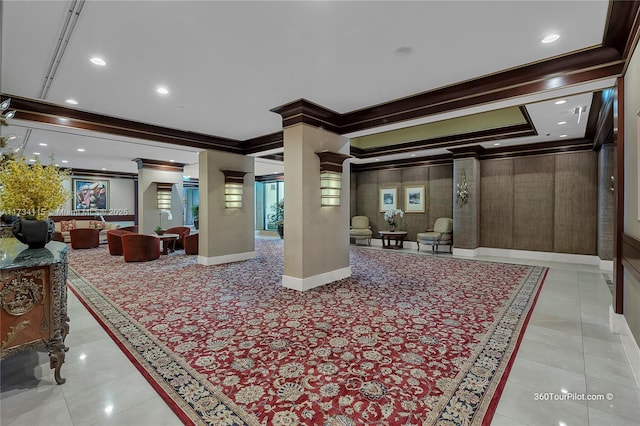 tiled living room with crown molding and ornate columns