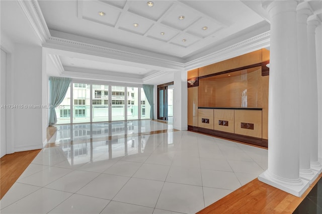 tiled living room featuring ornate columns, crown molding, a raised ceiling, and coffered ceiling