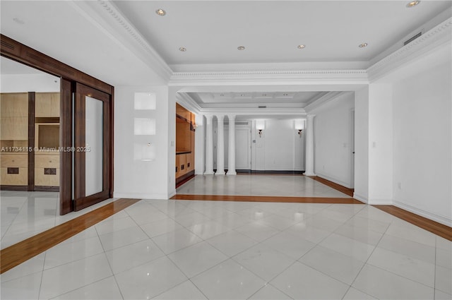 interior space featuring a tray ceiling, ornamental molding, and light tile patterned flooring