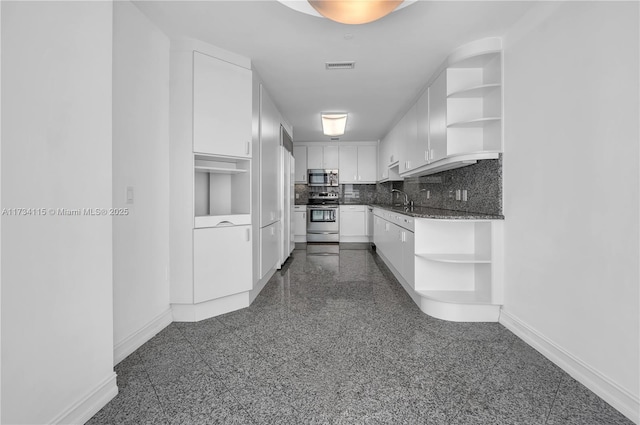 kitchen with white cabinetry, sink, decorative backsplash, and stainless steel appliances