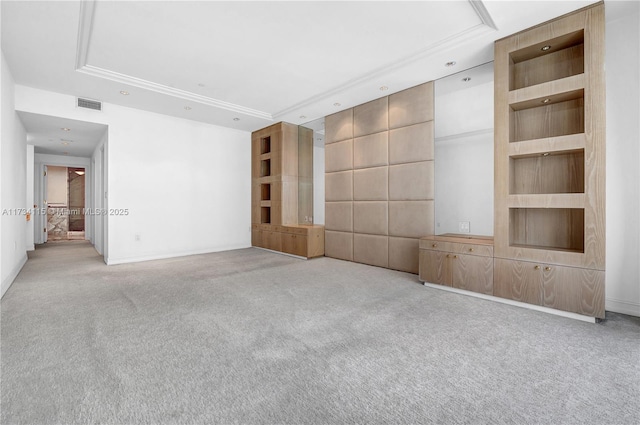 unfurnished living room featuring light colored carpet and a tray ceiling