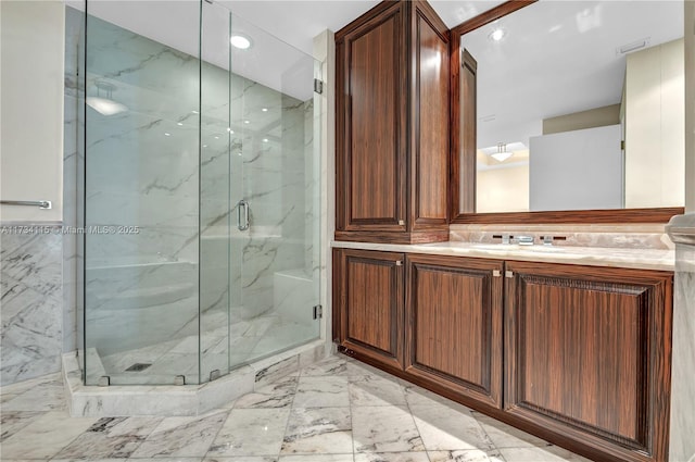 bathroom featuring vanity and an enclosed shower