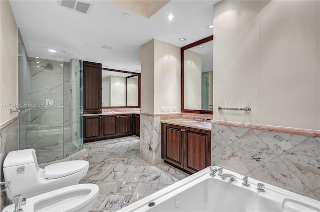 full bathroom with independent shower and bath, tile walls, vanity, toilet, and a bidet