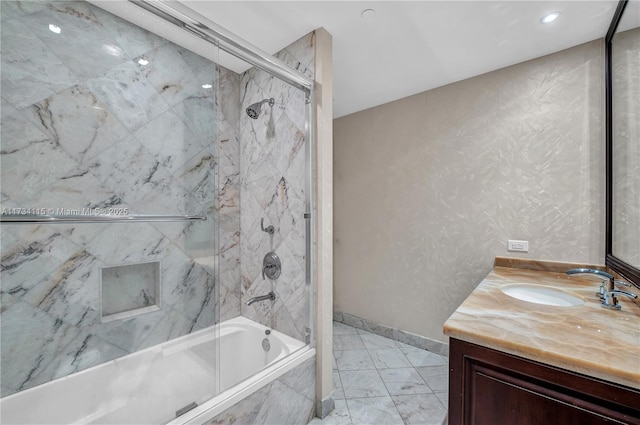 bathroom with vanity and bath / shower combo with glass door