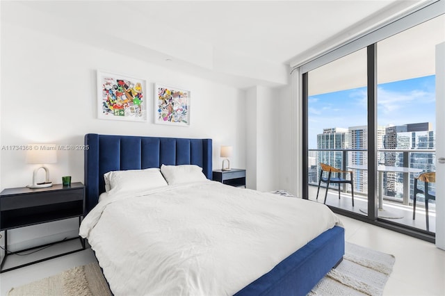 bedroom featuring expansive windows and access to exterior