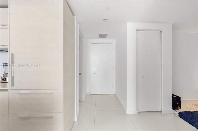 hallway with light tile patterned floors