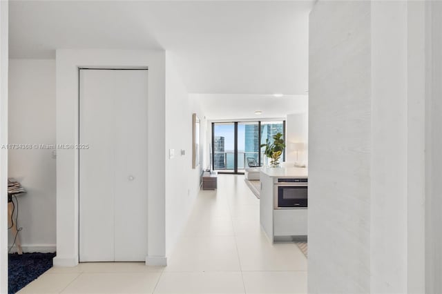 hall featuring light tile patterned flooring