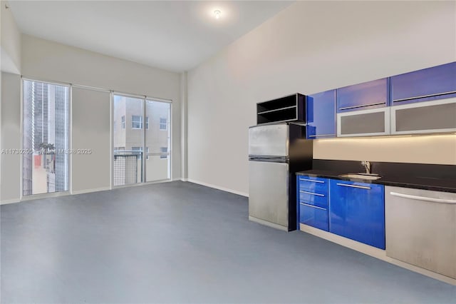 kitchen featuring sink, stainless steel appliances, and blue cabinetry