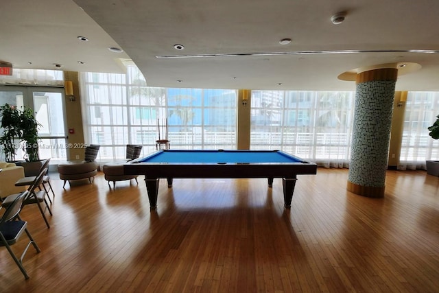 playroom with hardwood / wood-style flooring, pool table, and expansive windows