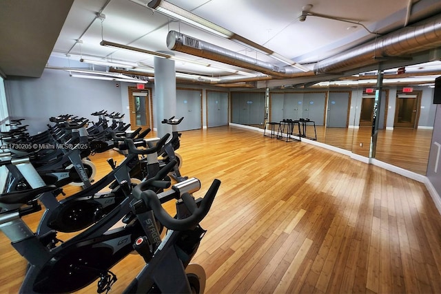 exercise room with hardwood / wood-style floors