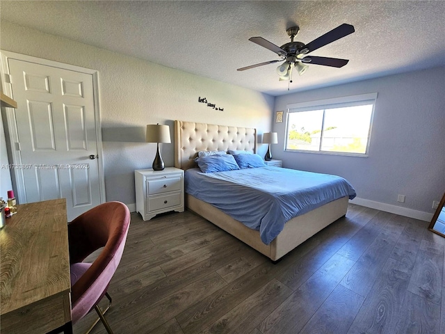 bedroom featuring a ceiling fan, dark wood-style flooring, a textured ceiling, and baseboards