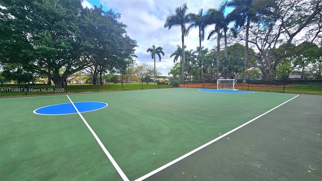 view of basketball court featuring fence