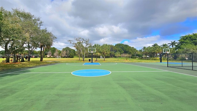 view of basketball court featuring community basketball court, a yard, a tennis court, and fence