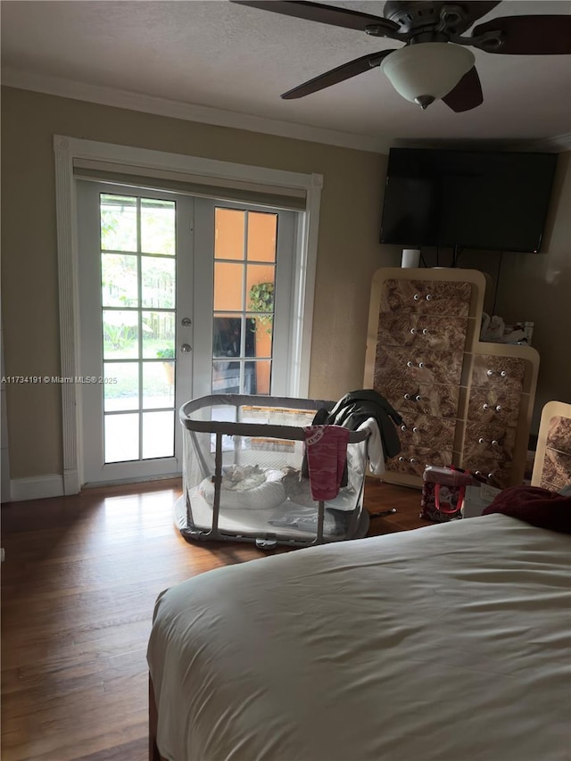 bedroom featuring hardwood / wood-style floors, ornamental molding, access to exterior, ceiling fan, and french doors