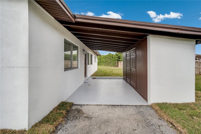 view of side of home with stucco siding