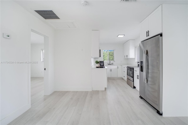 kitchen with visible vents, electric range oven, light wood-style floors, stainless steel refrigerator with ice dispenser, and white cabinetry