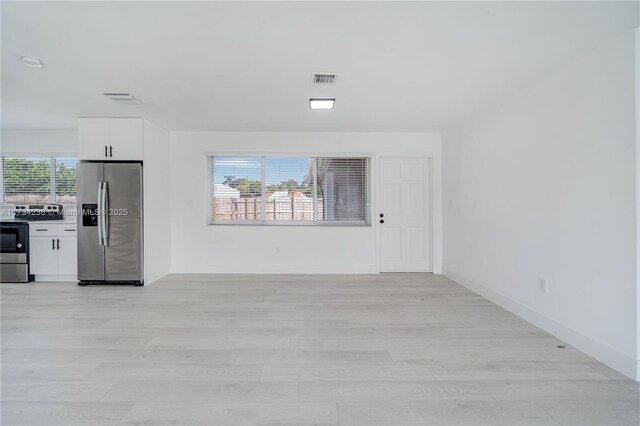 unfurnished living room featuring a healthy amount of sunlight