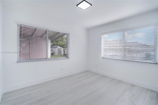 spare room with light hardwood / wood-style flooring