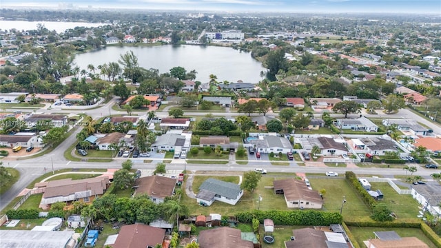 drone / aerial view with a water view and a residential view