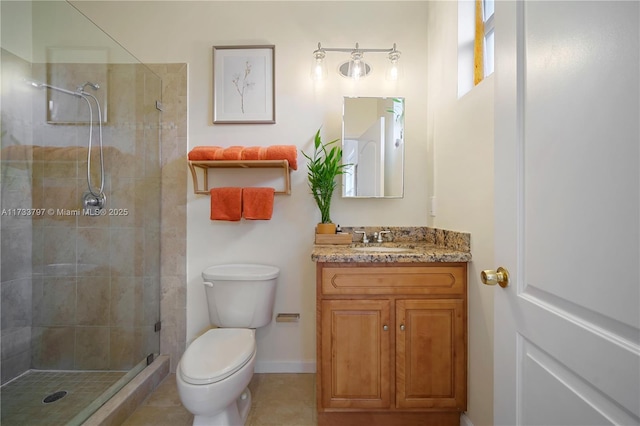 bathroom featuring tile patterned floors, vanity, toilet, and an enclosed shower