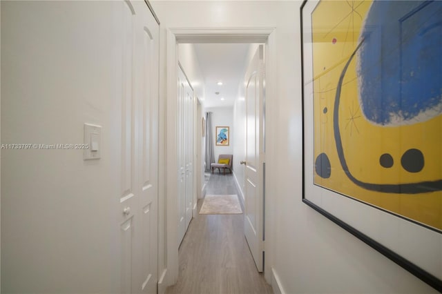 corridor with light hardwood / wood-style flooring