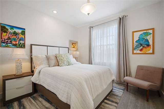 bedroom with dark hardwood / wood-style floors