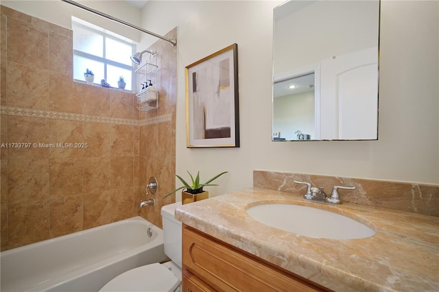 full bathroom featuring vanity, toilet, and tiled shower / bath combo