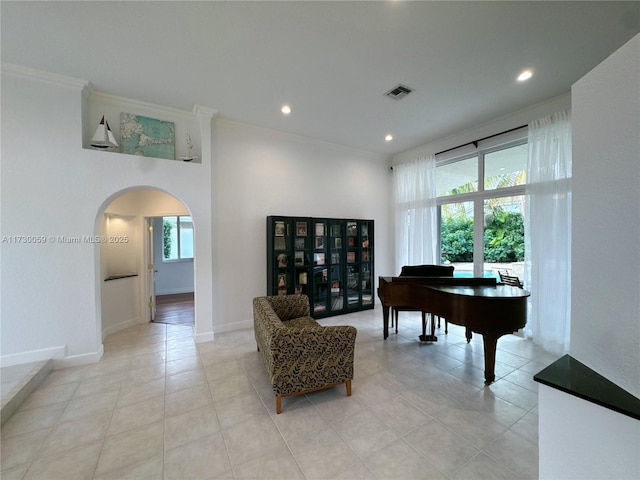 interior space with light tile patterned floors and ornamental molding