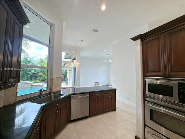 kitchen with dark brown cabinetry, sink, ornamental molding, appliances with stainless steel finishes, and backsplash