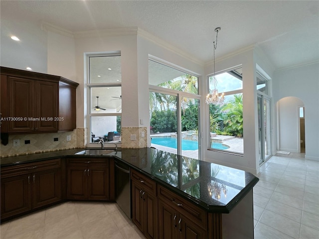 kitchen with dishwasher, sink, dark stone countertops, ornamental molding, and kitchen peninsula