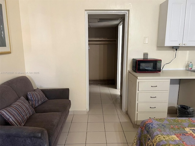 bedroom with light tile patterned floors and a closet