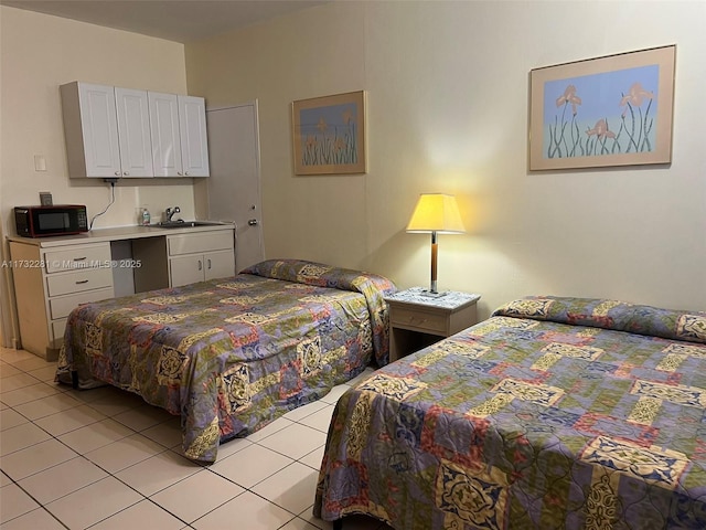 bedroom with sink and light tile patterned floors